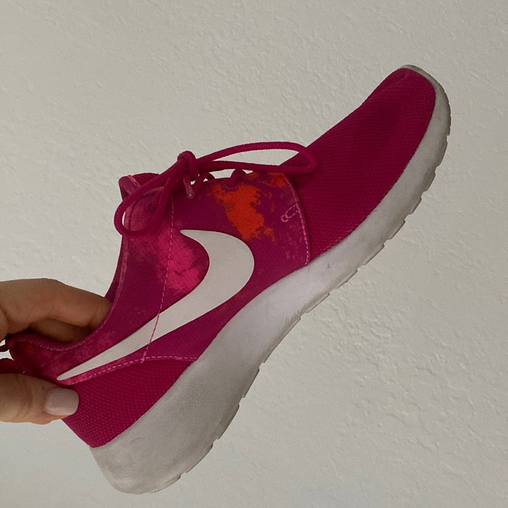 Pink Nike sneakers with orange print, size 7